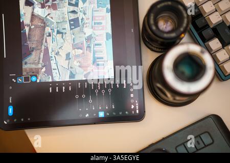 Poland, Poznan, 12/30/2024 Photo editing equipment lens graphic tablet from above Stock Photo