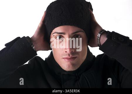 Headshot of young man with wool hat and winter coat, isolated on white Stock Photo