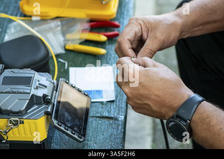 Device for mounting optical cable. Optical internet Technology concept. Optical fiber assembly Stock Photo