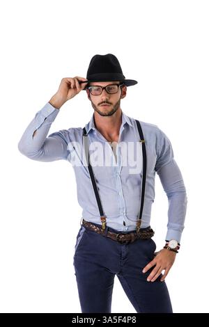 Handsome elegant young man with elegant shirt, suspenders and hat, isolated on white, smiling and looking at camera Stock Photo