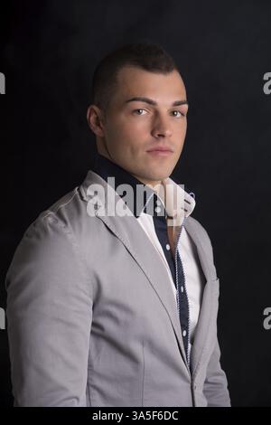Portrait of handsome young man with shirt and jacket, looking at camera Stock Photo