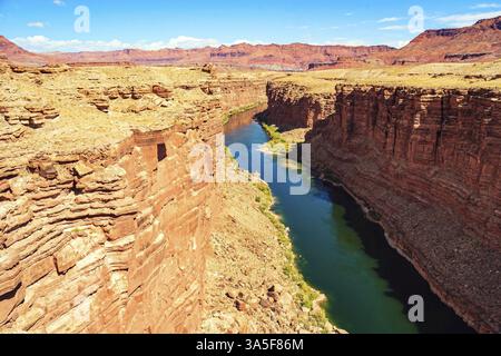 United States of America. Deep and narrow canyon of the Colorado River. The multicolored canyon of red Navajo sandstones. The water of the Colorado Ri Stock Photo