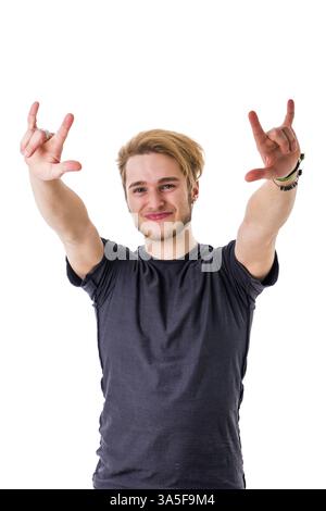 Smiling bearded young man with hands up showing horns with hands Stock Photo