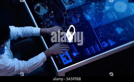 Business person works on laptop. Hands type on keyboard. Cyber security tech concept shown on screen. Lock, code graphic shows protection. Person mana Stock Photo