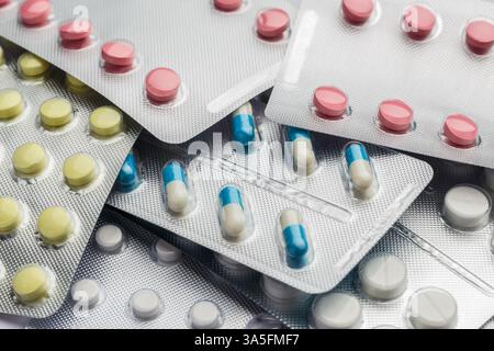 Pile of multi-colored pills in blister pack close-up Stock Photo