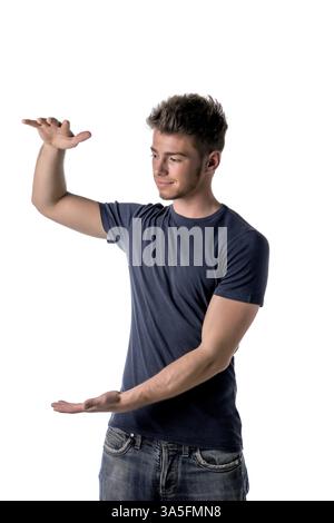 Handsome young man holding empty vertical space between hands for your product or text Stock Photo