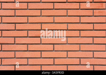Background from a wall made of clean orange bricks Stock Photo