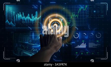 A hand interacts with a futuristic digital interface displaying graphs and data visualizations on a dark screen. Stock Photo