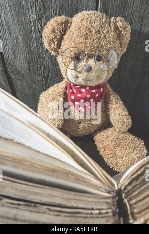 Children teddy bear with old vintage book Stock Photo