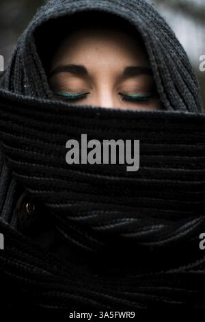 Closeup of the detail of the close eyes of a veiled woman made up Stock Photo