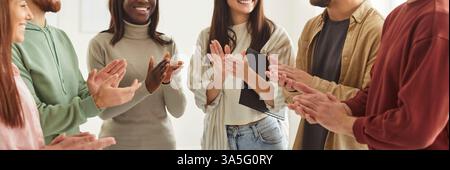 Team of happy young multiethnic successful business people applauding each other Stock Photo