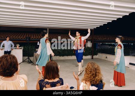 Montenegro, Lovcen - July 09, 2024: Man and woman in national Montenegrin costumes dance on stage in front of the audience Stock Photo