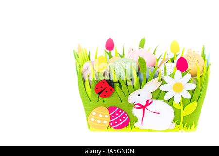 Green basket with multicolored Easter eggs isolated on white background with copy space Stock Photo