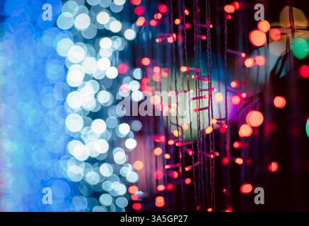 Abstract colorful bokeh orbs on dark background, vibrant defocused light dots pattern, festive overlay texture for photo editing, blurred bright circu Stock Photo