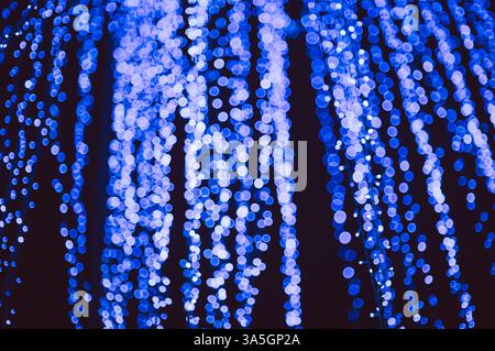 white and blue Bokeh Lights Abstract Background. bokeh background with bright lights on night. Stock Photo