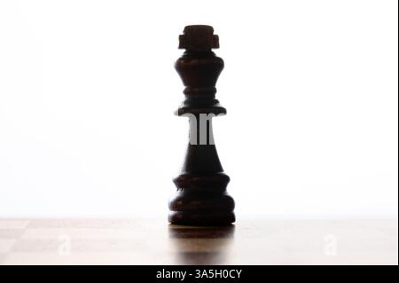 Black king chess piece on a white background, horizontal Stock Photo