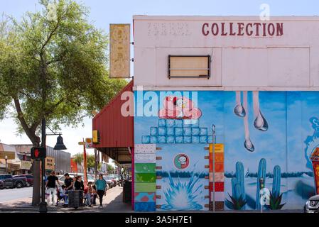 Looking down Main Street, people on sidewalk, colorful side wall of Chula Michoacán, an ice cream and yoga shop, McAllen, Hidalgo County, Texas. Stock Photo