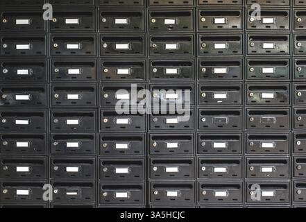 Many Black color mailboxes on wall Stock Photo