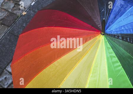 Multicolored umbrella in rainy day. Bulgaria, Plovdiv Stock Photo