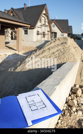New build house and blueprints. Construction site Stock Photo