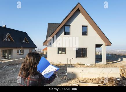 New build house and blueprints. Construction site Stock Photo