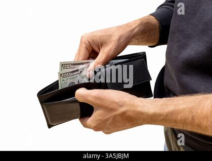 Cutout of black leather wallet with US dollar bills in the hands of a male person Stock Photo