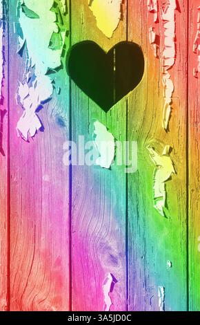 A heart shape cut out of a wooden board with peeling paint. Stock Photo