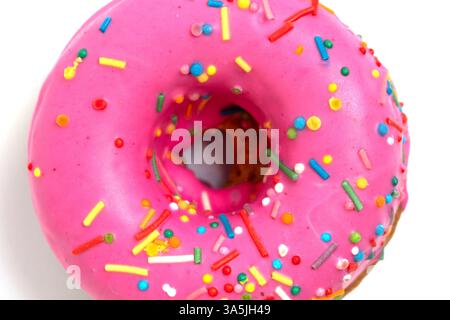 Pink donut with sprinkles isolated on white background, top view Stock Photo