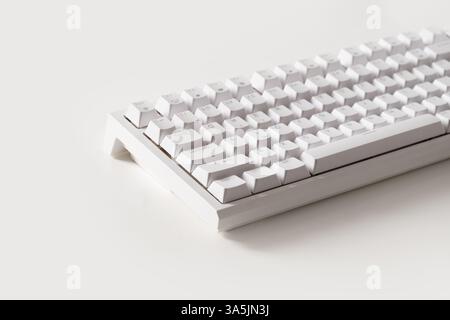 Modern white mechanical keyboard on white background. Custom build keyboard. Close up. Stock Photo