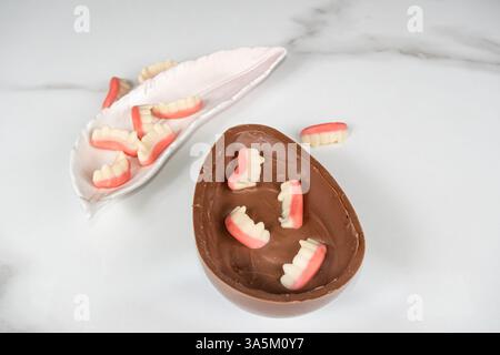 Chocolate Easter egg with strawberry and raspberry filling for children. Stock Photo