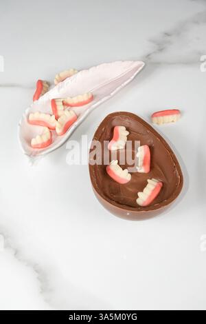 Chocolate Easter egg with strawberry and raspberry filling for children vertical. Stock Photo