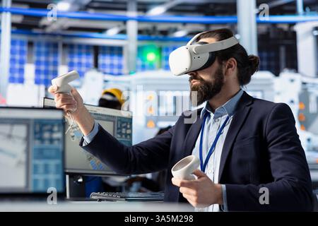 Technician using VR goggles to monitor solar panel manufacturing plant assembly lines. Worker using virtual reality to troubleshoot photovoltaic equipment, ensuring seamless production workflow Stock Photo