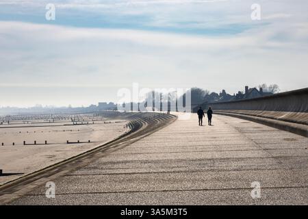 Anti-flooding Dymchurch Sae Wall and groynes along the beach in Romney Marsh area, Kent, England Stock Photo
