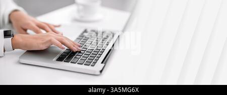 Unrecognizable lady working on her laptop at office Stock Photo