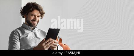 Happy mature businessman using tablet pc, looking at screen Stock Photo