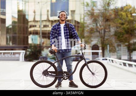 Portrait of african american guy standing with his bike Stock Photo