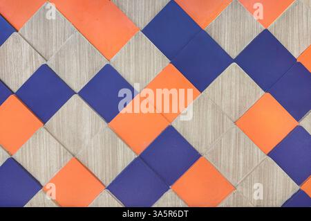 Close up series of diamond shapes pattern in wood, blue, and orange color finish. Vibrant and edgy vibes, suitable for wall panels and finishes. Seaml Stock Photo