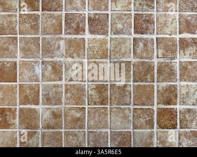 Unique natural stone marble tiles wall texture in mix of brown, orange, and red color with random abstract veins. Honed and rough outdoor marble tiles Stock Photo