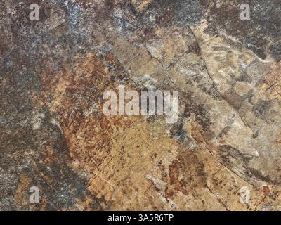 Close up of rusty and weathered granite stone texture, suitable for outdoor and exterior flooring. Oxidized, copper and grey color. Seamless stone bac Stock Photo