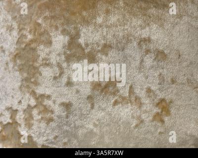 Close up of decorative satin gold and brass fabric in random grunge and dirt texture. Golden fabric seamless background texture. Stock Photo