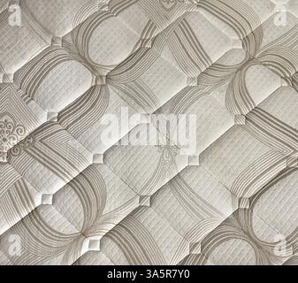 Close up of random white and brown bed linen fabric with 3d diamond shape texture. Suitable for bed linen, cover, wallpaper, or upholstery. Seamless Stock Photo