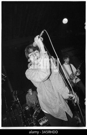 NOTE: OASIS ARE THE SUPPORT BAND AND TONY McCARROLL IS PLAYING THE DRUM KIT OF THE HEADLINERS WHITEOUT. OASIS, FIRST NATIONAL TOUR, 1994: Liam Gallagher, Noel Gallagher and original drummer Tony McCarroll of Oasis at The Fleece and Firkin in Bristol, England, March 30 1994. At this early gig the legendary band played as a support to another up-and-coming indie group called Whiteout. Photograph: Rob Watkins.  INFO: In 1994, Oasis burst onto the British music scene with their debut album Definitely Maybe, redefining Britpop with raw energy and anthemic songs. Stock Photo