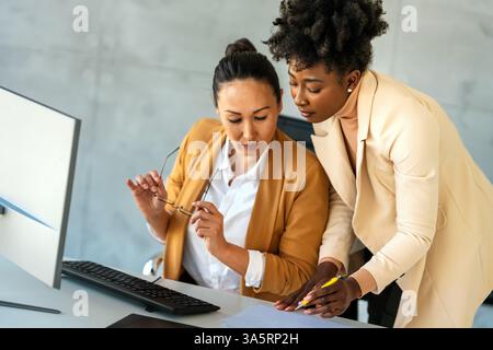 Happy businesspeople laughing while collaborating on a new project in an office. Stock Photo