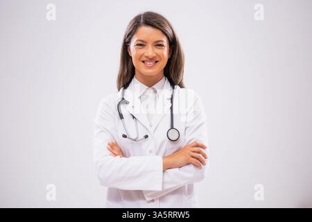 Studio shot portrait of happy female doctor who is satisfied after successful treatment. Stock Photo