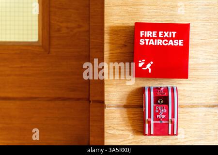 Fire alarm device that installed on building wall, press the button to activate sound in emergency fire case. Safety equipment object photo, close-up. Stock Photo