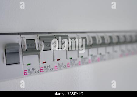 Power distribution board with row of circuit breakers and switches. Electrical panel with fuse box. Concept of home electricity safety, power distribu Stock Photo