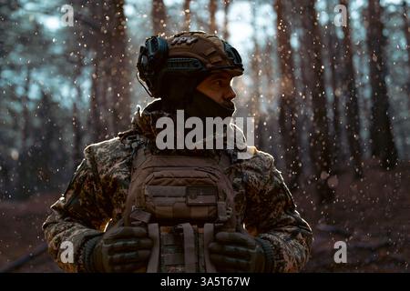 Portrait of a Ukrainian armed forces soldier in full equipment in the forest, concept of military conflict in Ukraine Stock Photo