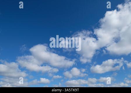 bright blue sky and white puffy clouds background Stock Photo