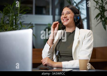 Professional Woman Engaged in a Video Conference Call From a Modern Office Setting Stock Photo
