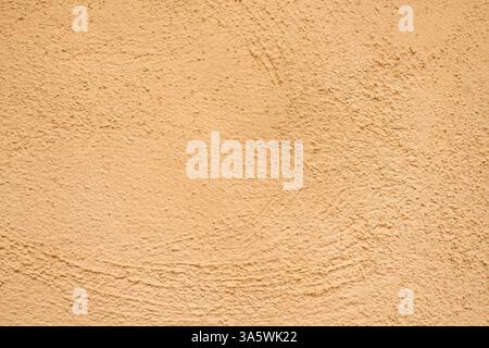 Yellow stucco wall texture with small bumps, rough plaster surface. Warm-toned background with detailed imperfections, ideal for design, architecture, Stock Photo